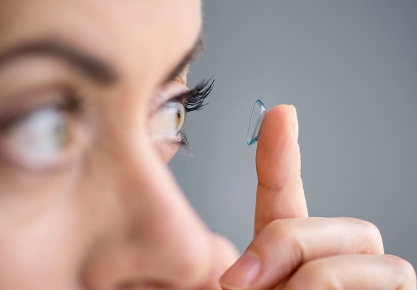 fotografia de persona colocándose lentes de contacto